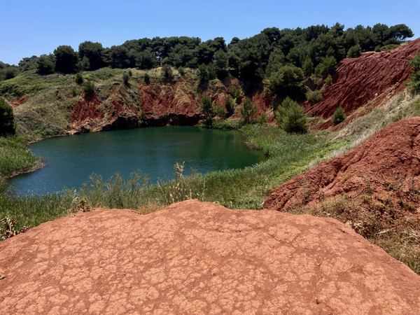 Maurizio Zanetti — Otranto, the former bauxite quarry. Red rocks and an emerald-green lake.
