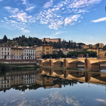 Florence, Italy<br />
 The Arno flows like a mirror under the Ponte alle Grazie.<br />
 In August 1944, the bridge was destroyed by the Germans as they retreated before the advance of allied forces in World War II.  After the war ended, a competition was launched to create a new design for the replacement bridge.  It won a project of a group made up of architects including Giovanni Michelucci, Edoardo Said, Edoardo Detti, Riccardo Gizdolich and Danilo Know and an engineer, Piero Melucci;  they presented a project consisting of four thin piers with thin arches between them.  The new bridge was completed in 1953. The new design is in harmony with the surrounding city, although it does not reflect the shape of the previous bridge.<br />
<br />
Firenze, Italia<br />
L'Arno scorre come uno specchio sotto il Ponte alle Grazie.<br />
Nell'agosto 1944, il ponte fu distrutto dai tedeschi mentre si ritiravano prima dell'avanzata delle forze alleate nella seconda guerra mondiale.  Dopo la fine della guerra, fu indetto un concorso per creare un nuovo design per il ponte sostitutivo.  Vinse il progetto di un gruppo formato da architetti tra cui Giovanni Michelucci, Edoardo Said, Edoardo Detti, Riccardo Gizdolich e Danilo Know e un ingegnere, Piero Melucci; essi presentarono un progetto costituito da quattro moli sottili con sottili archi tra loro.  Il nuovo ponte fu completato nel 1953. Il nuovo design è in armonia con la città circostante, anche se non rispecchia la forma del ponte precedente.