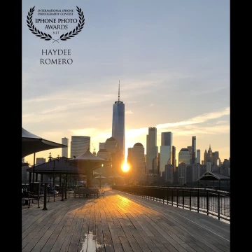 The Autumn Sun rises behind the World Trade Center in Lower Manhattan, as seen from the Exchange Place Pier in Jersey City on a recent weekend. For once, the pier was empty of people.