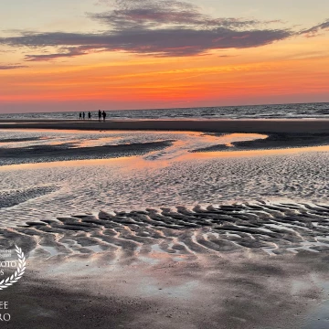 The rising sun at Hilton Head Island in South Carolina creates a ripple of shadows and light on the beach where the constant ebb and flow of the tide has sculpted the sand.