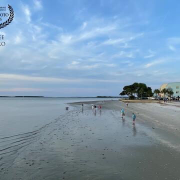 This is the small beach by the lighthouse at Harbor Town in Hilton Head Island, where holidaymakers and travelers come to watch the sunset and to stroll along the sand where the receding leaves a treasure trove of seashells and marine life.