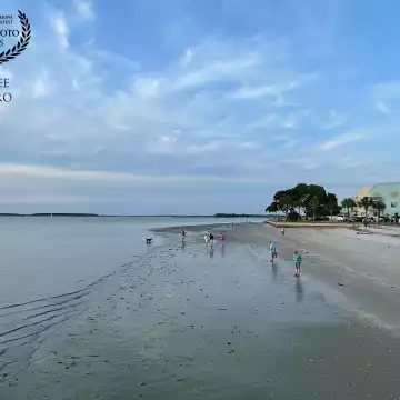 This is the small beach by the lighthouse at Harbor Town in Hilton Head Island, where holidaymakers and travelers come to watch the sunset and to stroll along the sand where the receding leaves a treasure trove of seashells and marine life.
