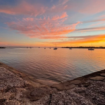 The sunrise paints the sky and ocean with yellow, pink and orange at the St Augustine Bay. An historic town founded in 1565, St. Augustine is the oldest continuously occupied European settlement in the United States.