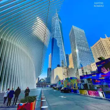 One wing of the Oculus building with the World Trade Center at the front. The structure of the Oculus is the portrayal of a bird about to take a flight, it was designed by the architect Santiago Calatrava.