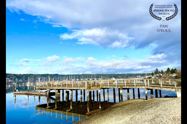 One of the 1st days of spring at the beach & the air smelled as fresh and crisp as this image depicts. The blue sky, the cloud reflection and the reflection of the oyster dock in the water created this composition of a perfect Pacific Northwest day<br />
“Oyster Dock Reflection”-2021