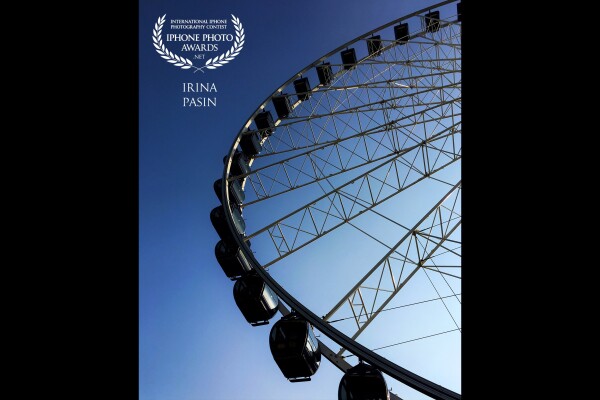 This image says 'summer holidays' to me. The perfect blue skies and the ferris wheel are the things that are commonly found on the summer breaks in the south of Europe. 