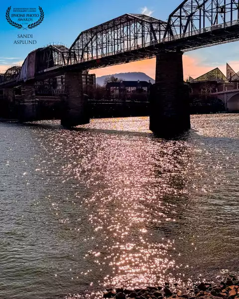 Sunset behind Lookout Mountain, Tennessee shines its evening light across downtown Chattanooga casca...