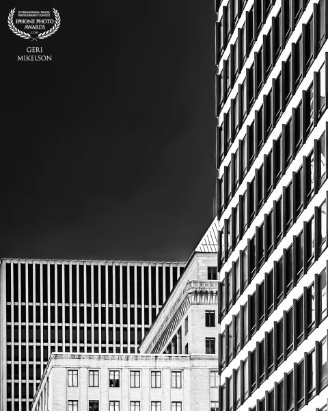 I don't get the opportunity to shoot in urban environments that often. I was really drawn to the contrasts in this scene though. The juxtaposition of an older building sandwiched between two modern, the contrast between light and dark, and multiple patterns.