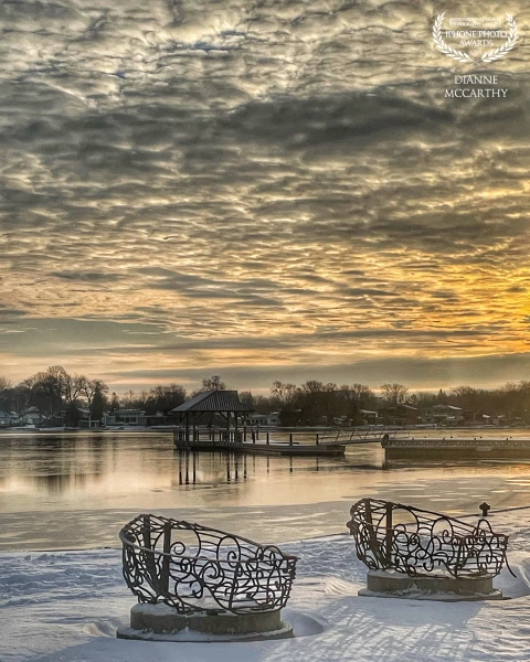 One of the very rare days of sun in Ontario (Canada) this winter, I liked the golden, heavy sky, the silvery smooth foreground and the curls of the iron boat sculptures.