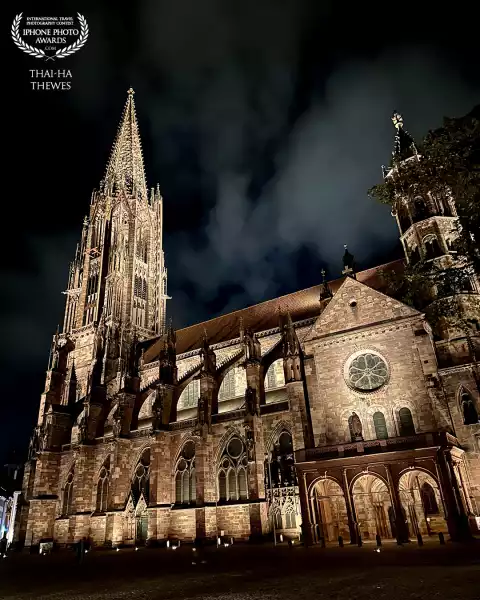 Night shot of the Freiburg Minster, Black Forest, Germany, also called The Cathedral of Our Lady. The Roman Catholic church was built from around 1200 to 1513 in the Gothic style. The tower which measures 116 meters in height survived the bombings in World War II and contains 16 bells (the oldest from 1258).