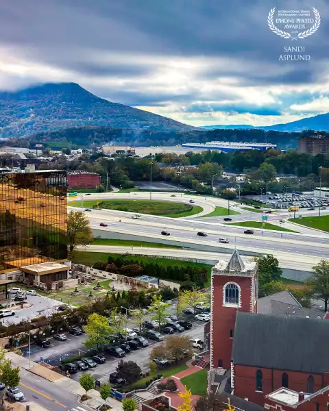 Taken from the 17th floor of an office building in downtown Chattanooga, Tennessee, a historic church steeple anchors the right of this view with Lookout Mountain hovering over the city on the left.