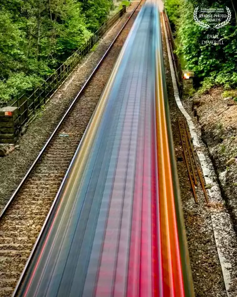 A train travelling at speed. iPhone set on 'Live Mode' then Long Exposure hand held