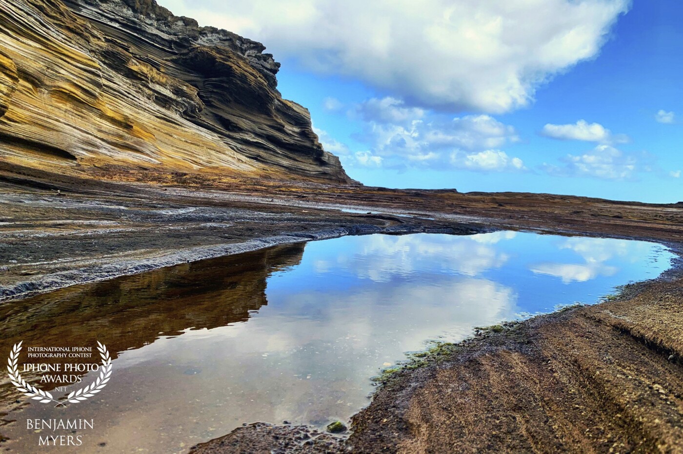 I climbed down off of the main road under a bridge to take this shot of the reflections in the water. The waves crash against the rocks and leave giant pools behind as the Pacific retreats back, away from the cliff. It was a beautiful day. 