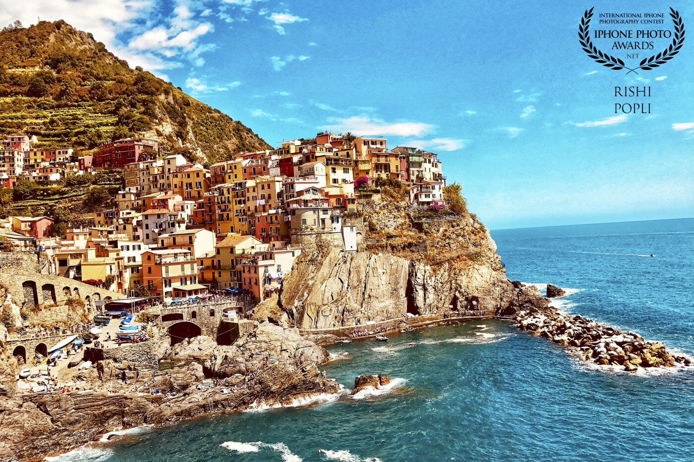 This picture was taken during a family vacation to Cinque Terre Province of La Spezia, Italy. Cinque Terre is a string of seaside villages on the Italian Riviera coastline. 5 towns unique to their look with colorful houses and amazing terrain. I took this photograph in the 4th town of Manarola which I thought was breathtaking.  