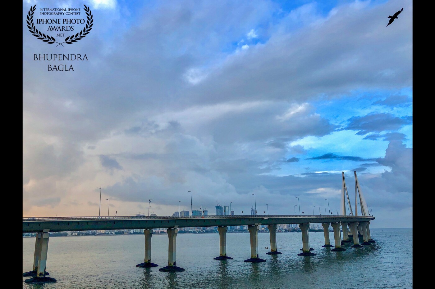 This was shot during my recent trip to Mumbai. I had captured this from the Bandra Fort early morning right after the sunrise. The Mumbai Sea Link Bridge looked really amazing right after the little showers that happened this morning as I had gone to shoot. The clouds and the eagle flying on the top made the perfect moment and I had to capture it. Overall the experience was unforgettable and the whole scene looked quite dramatic to be true. 