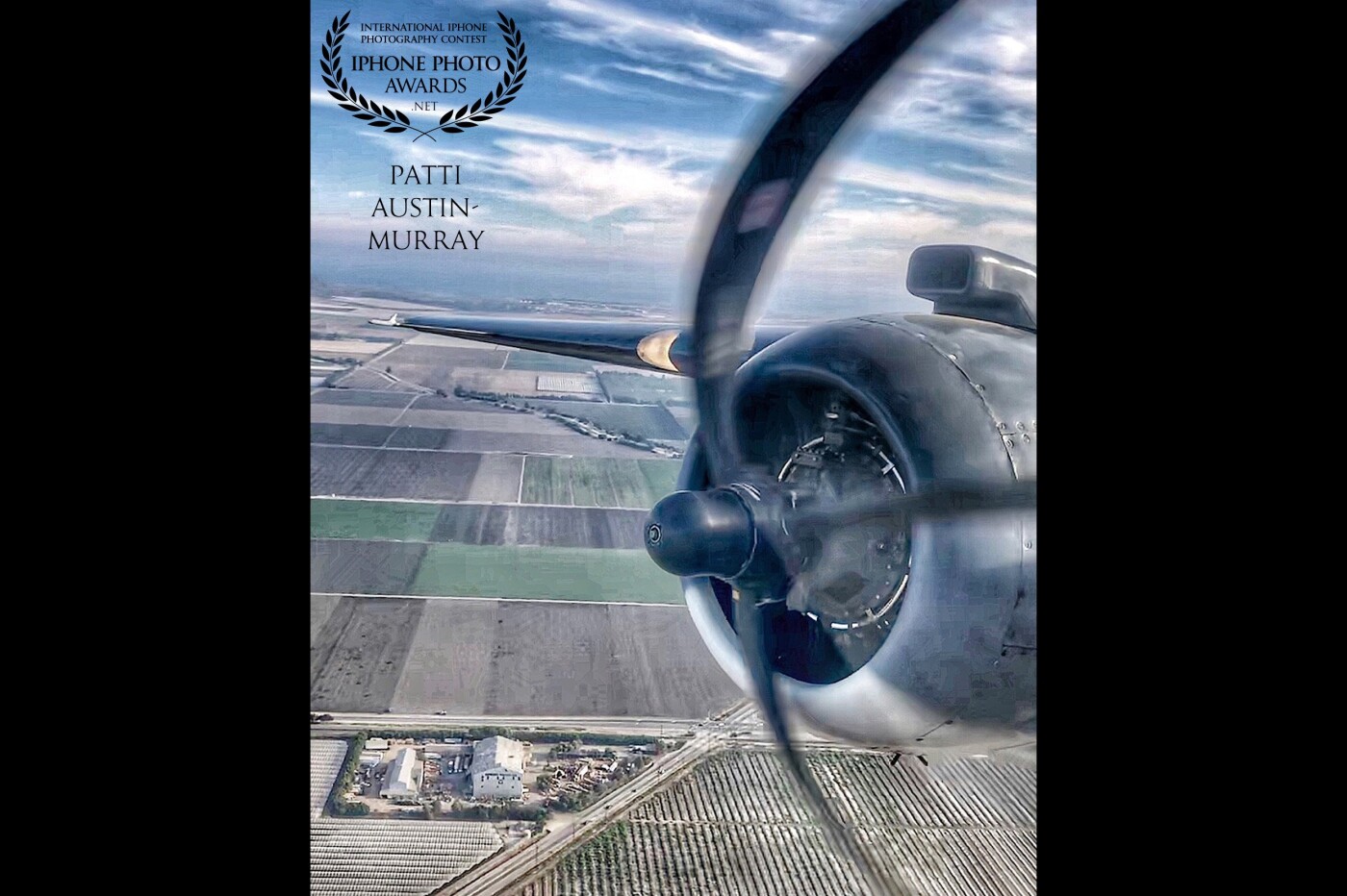 I shot this photo from the single front gunner seat, through the plexi, of a historic PBJ-1J which is the Marine equivalent of the B25 Bomber.  These aircraft were built during WWII - this particular aircraft was a 23 year, a labor of love, restoration project. She now flies airshows, etc. and serves as a grand reminder of US military air history.  On this particular occasion, she carried a crew of four and seven passengers - I was one of the lucky ones, to be sure! In order to access the single front gunner seat, you had to shimmy on your stomach some 5ft up a very narrow 'tunnel' and then climb into your seat. This nose section was some 65% plexiglass - could see the ground - with a swivel 50 caliber machine gun used during air combat.  While awaiting take-off, you 'bake' with the sun beating directly through, tho cooled off as we went airborne. Everyone wore protection ear coverings - those engines were unbelievably loud.  Was a ride of a lifetime - I was exhausted from smiling.   Below are the agricultural fields of Oxnard, Ventura County, California. A wondrous ride I will never ever forget. 