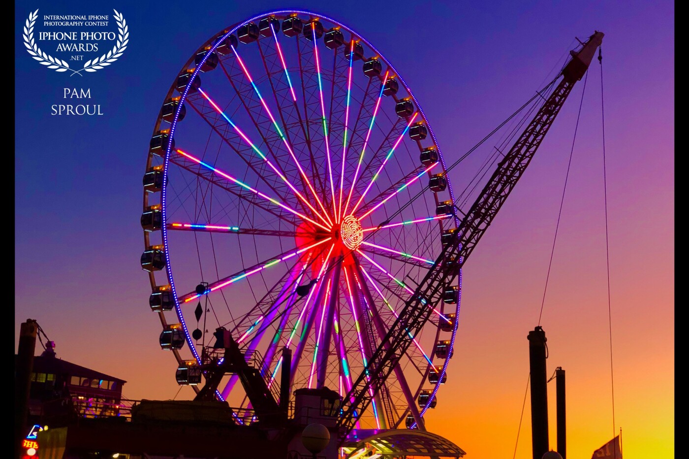 A beautiful night on our way to a jazz concert in downtown Seattle,  the sky went from a deep cobalt blue to these color layers and the big wheel lights happen to reflect all of the colors.<br />
“Rainbow Big Wheel” 2019