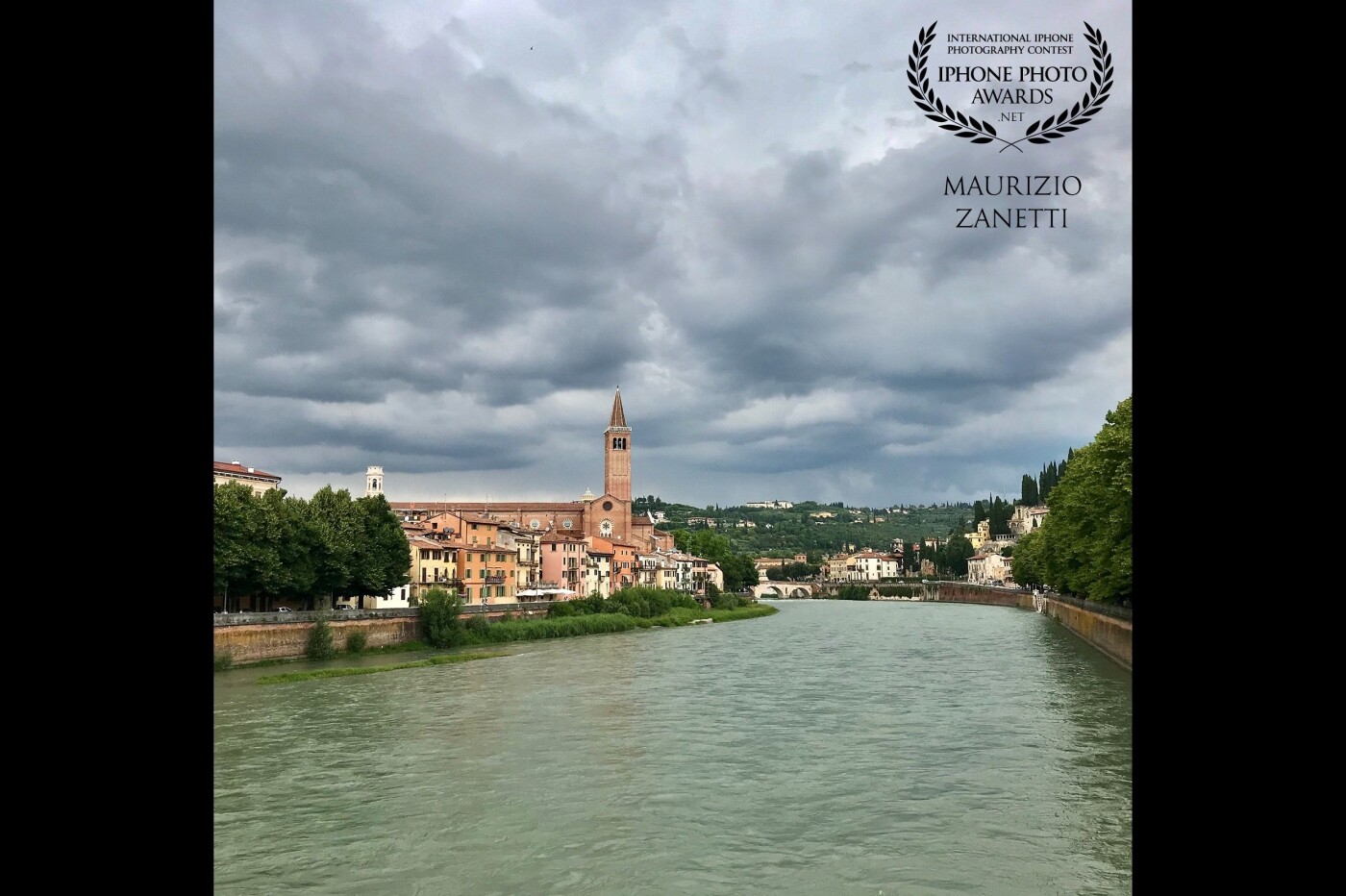 A classic view of Verona from Ponte Nuovo towards the Church of Sant'Anastasia and Castel San Pietro. Waiting for the storm coming.