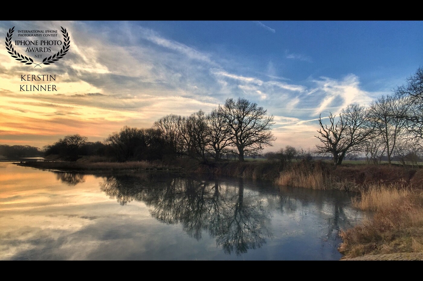 This picture was taken last winter. It was a cold and windless morning and so the landscape was reflected perfectly in the water. This picture was taken at the Alte Mulde in Bitterfeld.