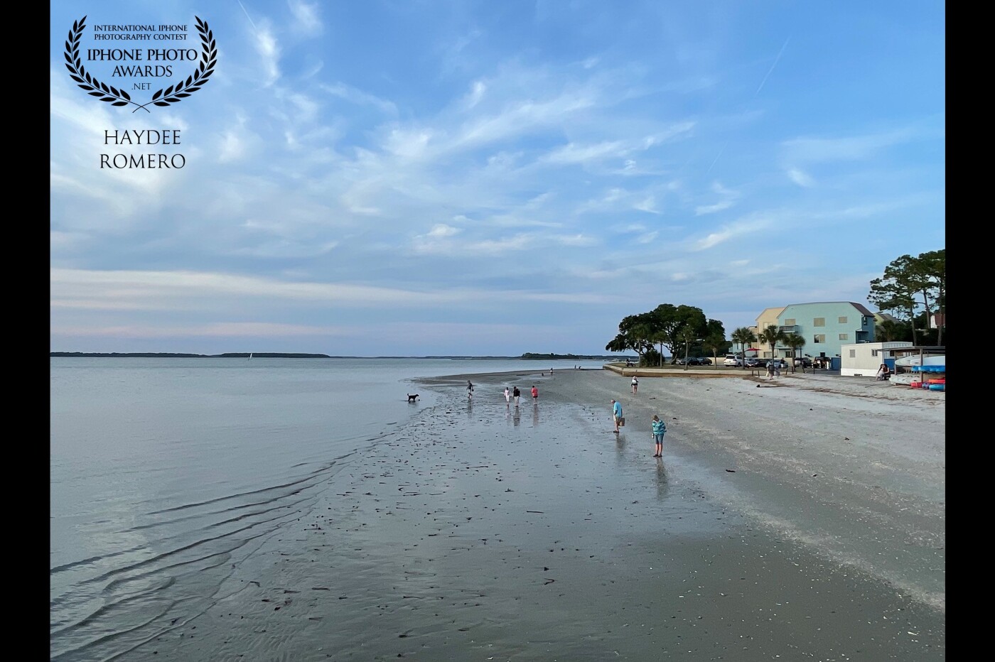 This is the small beach by the lighthouse at Harbor Town in Hilton Head Island, where holidaymakers and travelers come to watch the sunset and to stroll along the sand where the receding leaves a treasure trove of seashells and marine life.