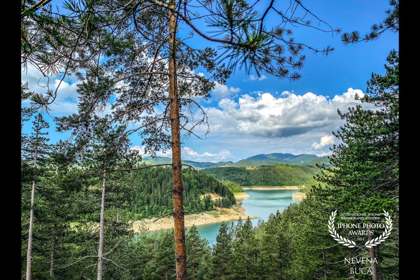 Beautiful view of the lake. The entire lake lies in the Tara National Park, one of five in Serbia. The lake is surrounded by vast woods as forestation of Tara mountain is 75%. Zaovine is the area where Josif Pančić, a leading Serbian botanist, discovered the endemic Serbian spruce in 1875 on the nearby Kik hill. <br />
Tara Mountain, Zaovine Lake, june 2021. Serbia.