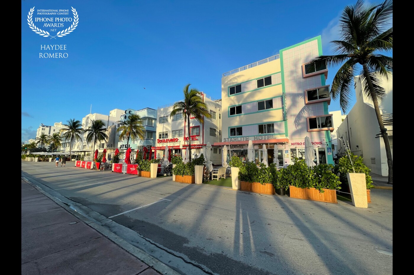 The light in the morning on Ocean Drive is so beautiful! The rays of the raising sun cast palm tree shadows on the Art Deco buildings of Ocean Drive, Miami Beach, Florida