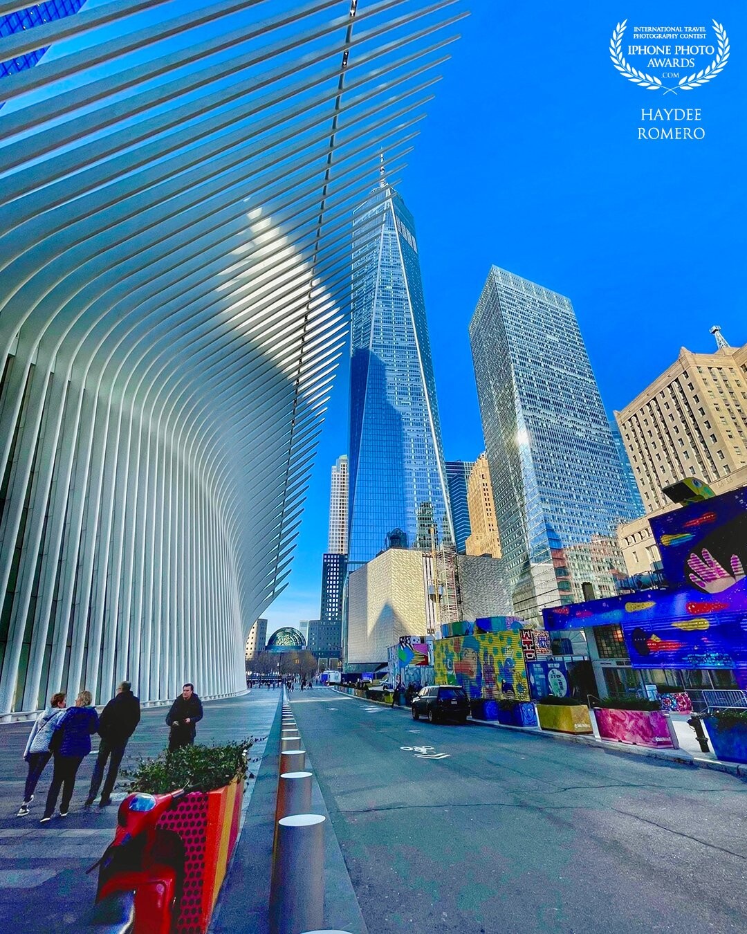 One wing of the Oculus building with the World Trade Center at the front. The structure of the Oculus is the portrayal of a bird about to take a flight, it was designed by the architect Santiago Calatrava.