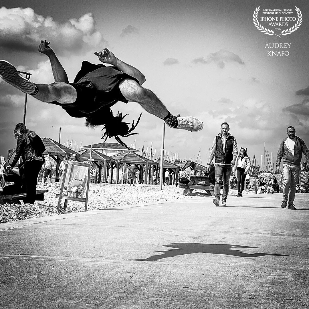 I took this picture in Tel Aviv , this guy is  a capoeira performer. I just seated on the floor and waited for the good moment .<br />
I was beyond happy to catch this image .