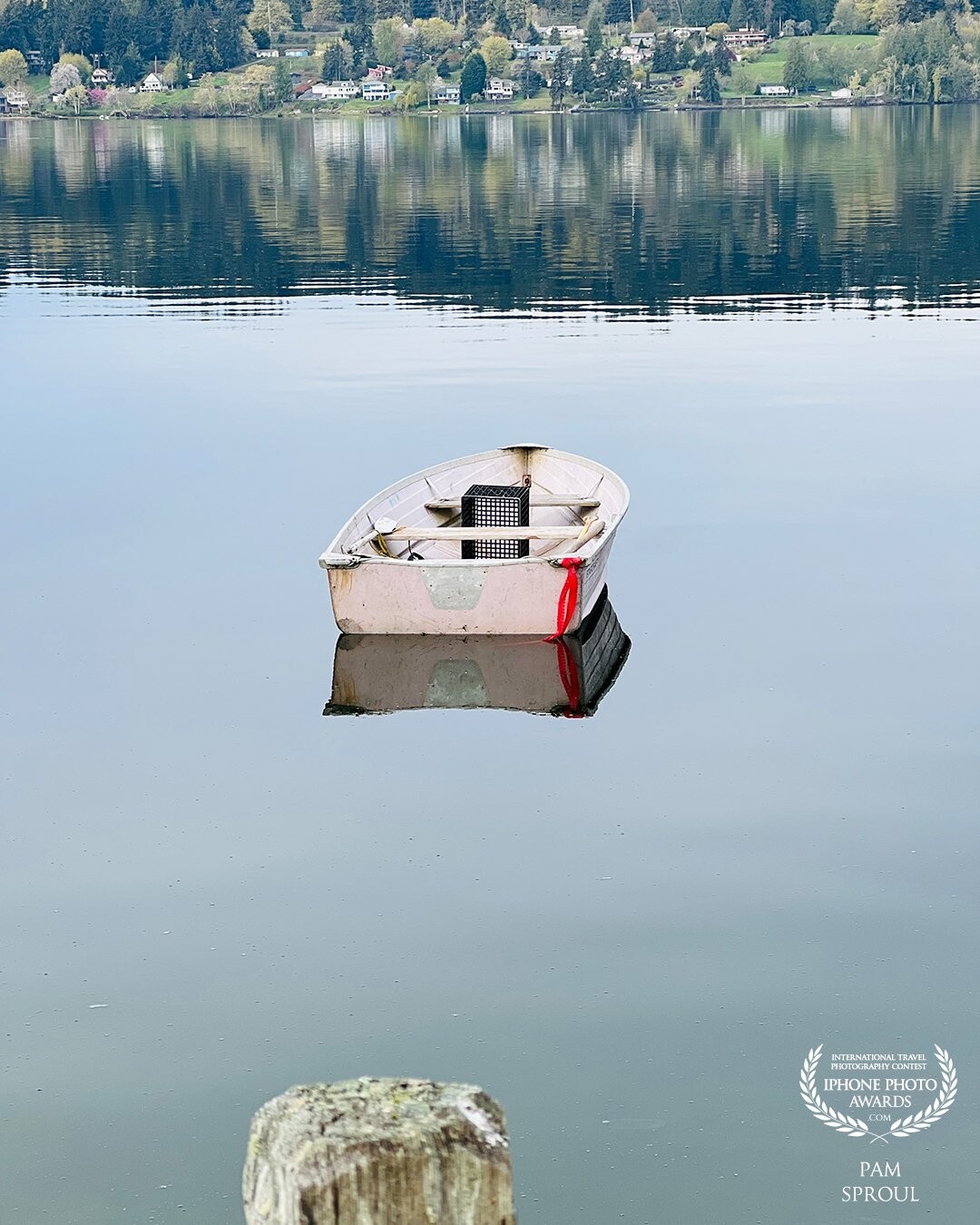 Walking along the seashore I came across this lovely dinghy floating on a glassy surface of the bay~ I was struck by the perfect mirror-like quality of the reflections around this small boat resting in Liberty Bay <br />
<br />
“Dinghy Reflections” -2022