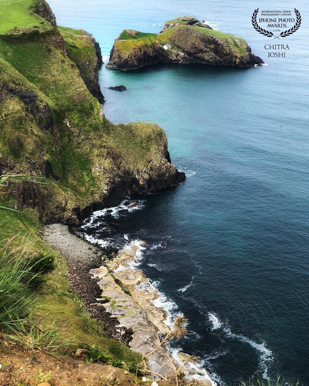 Location: Discovery Point, Northern Ireland, UK. This photo captures the National Trust" Carrick-a-Rede" rope bridge. It spans 20 metres (66 ft) and is 30 metres (98 ft) above the rocks/ocean below. It is definitely for strong hearts!
