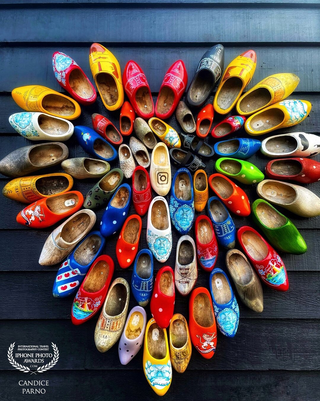 In the town of Zaans Schans, about 30 minutes from Amsterdam there is an authentic wooden shoe factory that has been preserving the art of wooden shoe making for 40 years.  This beautiful display of their work is shown on the outside of their workshop for all to admire.