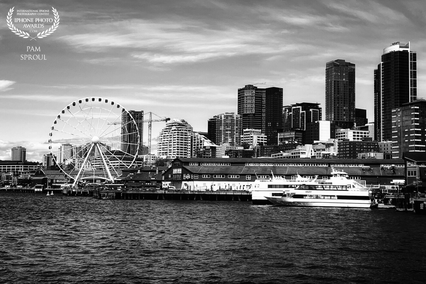 Grateful for the views from the ferry of the Seattle Waterfront that are ever changing. <br />
The Big Wheel set against the diverse buildings and the sky were perfect for a black and white capture with my iPhone <br />
<br />
#Seattle Waterfront Sky -2022