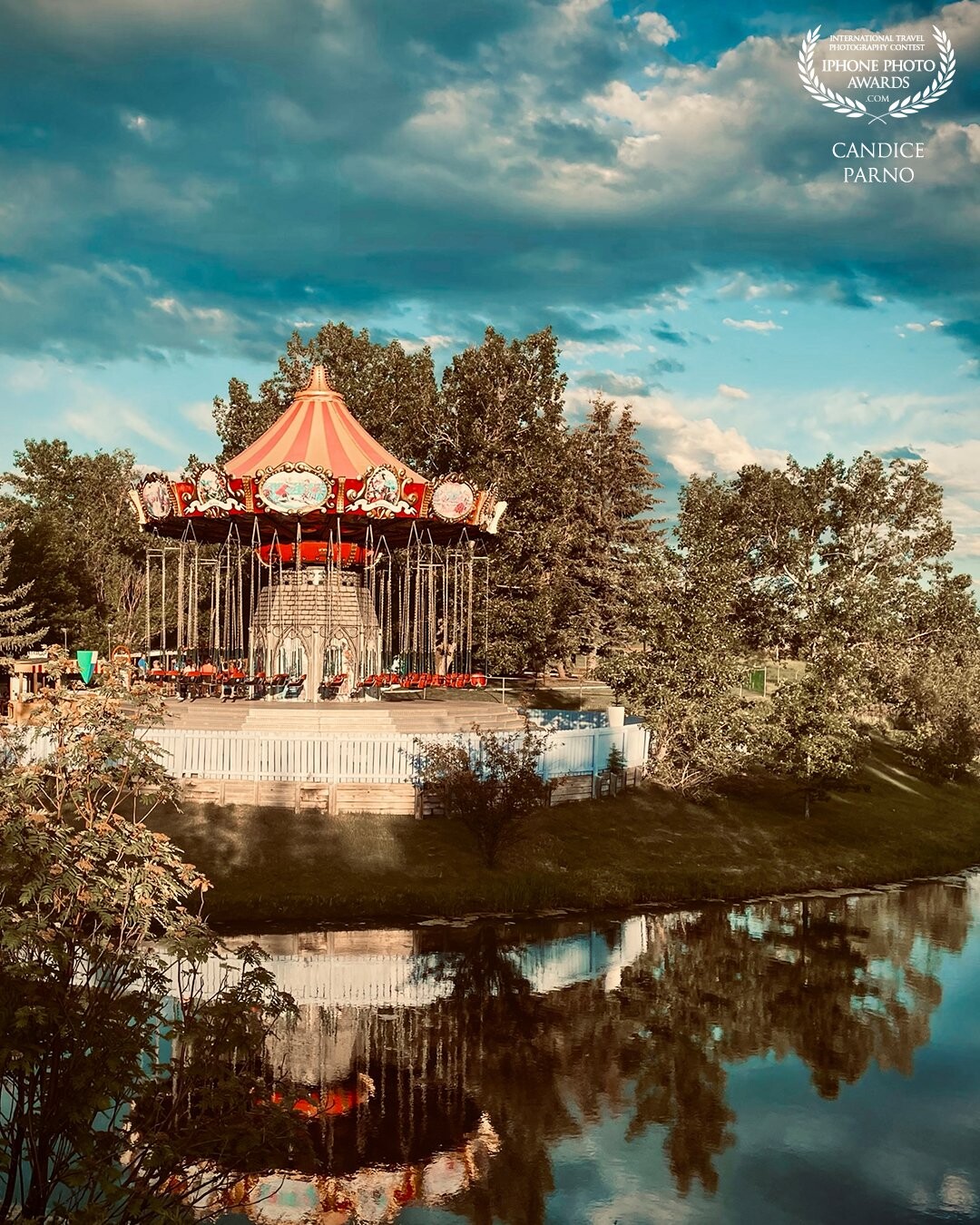 15 minutes outside of Calgary, Alberta is western Canada’s largest outdoor amusement park.  My son and I had just spent a very fun day riding all the rides and eating way to much cotton candy when I captured our favourite ride bathed in evening sun and reflected on the pond.  A perfect capture to end a perfect day!