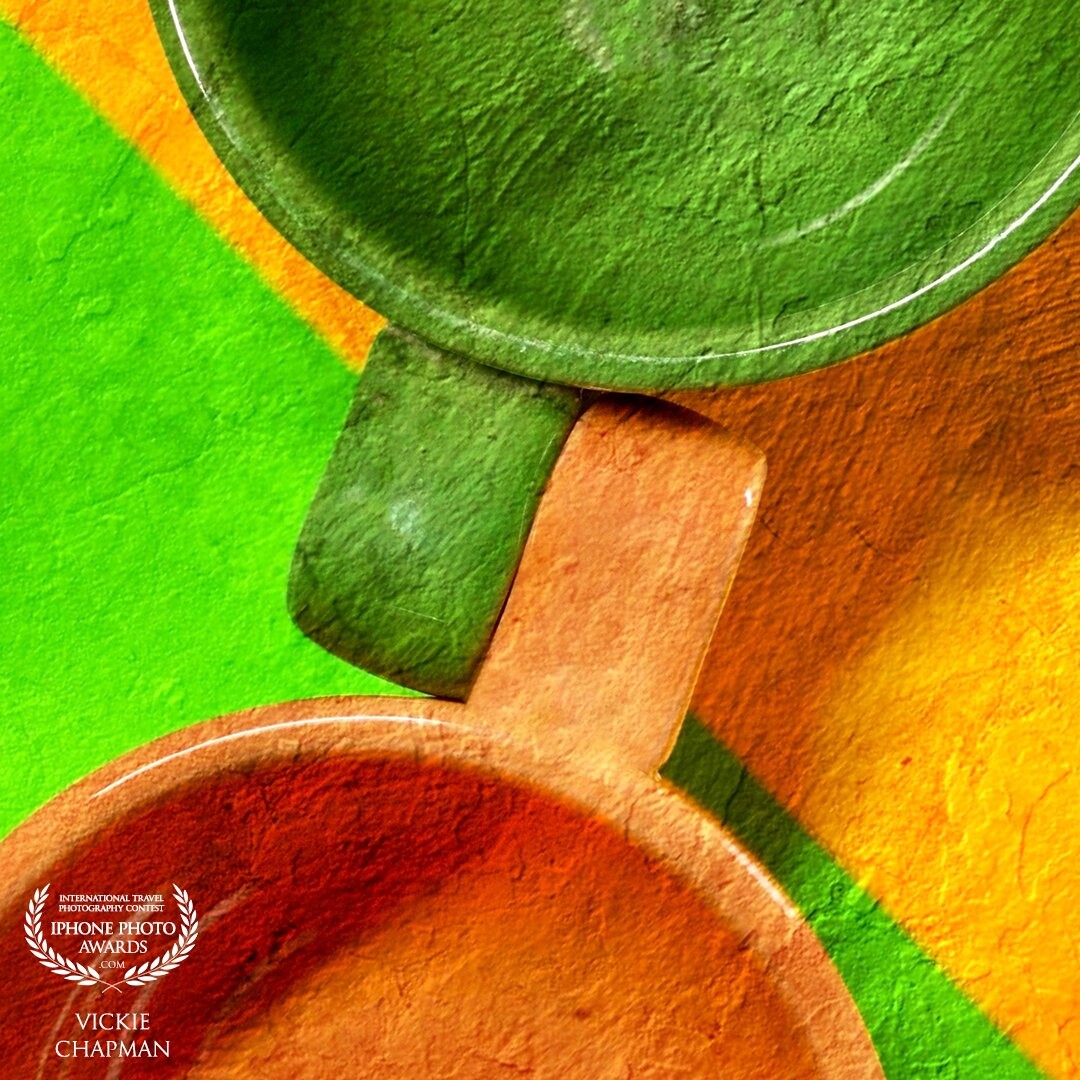 I was struck by the colors of everyday common objects and decided to start a journey of capturing those things. To see something everyday we become blind to the beauty and style before us. This is the first in the “Common Object” series. This was two large colorful mugs on contrasting color poster board. Edits made in the DistressedFX app.