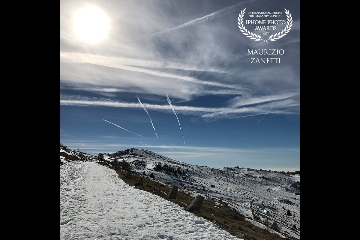 After a snowfall on the Lessinia plateau, a few kilometers north of Verona. Snow, clear sky, the contrails of some planes, silence. Picture taken with iPhone, no post production.