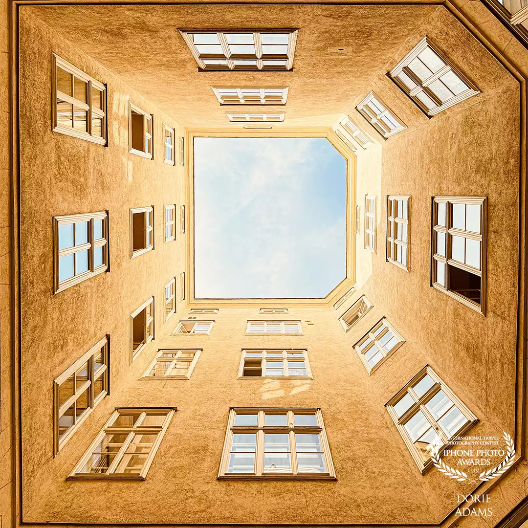 While I was walking, I saw an opened door and went inside the building and I saw an enclosed apartment with open air, an opportunity for looking up architecture shot and this is the outcome.<br />
Location: Vienna, Austria <br />
Device: iPhone 16Pro