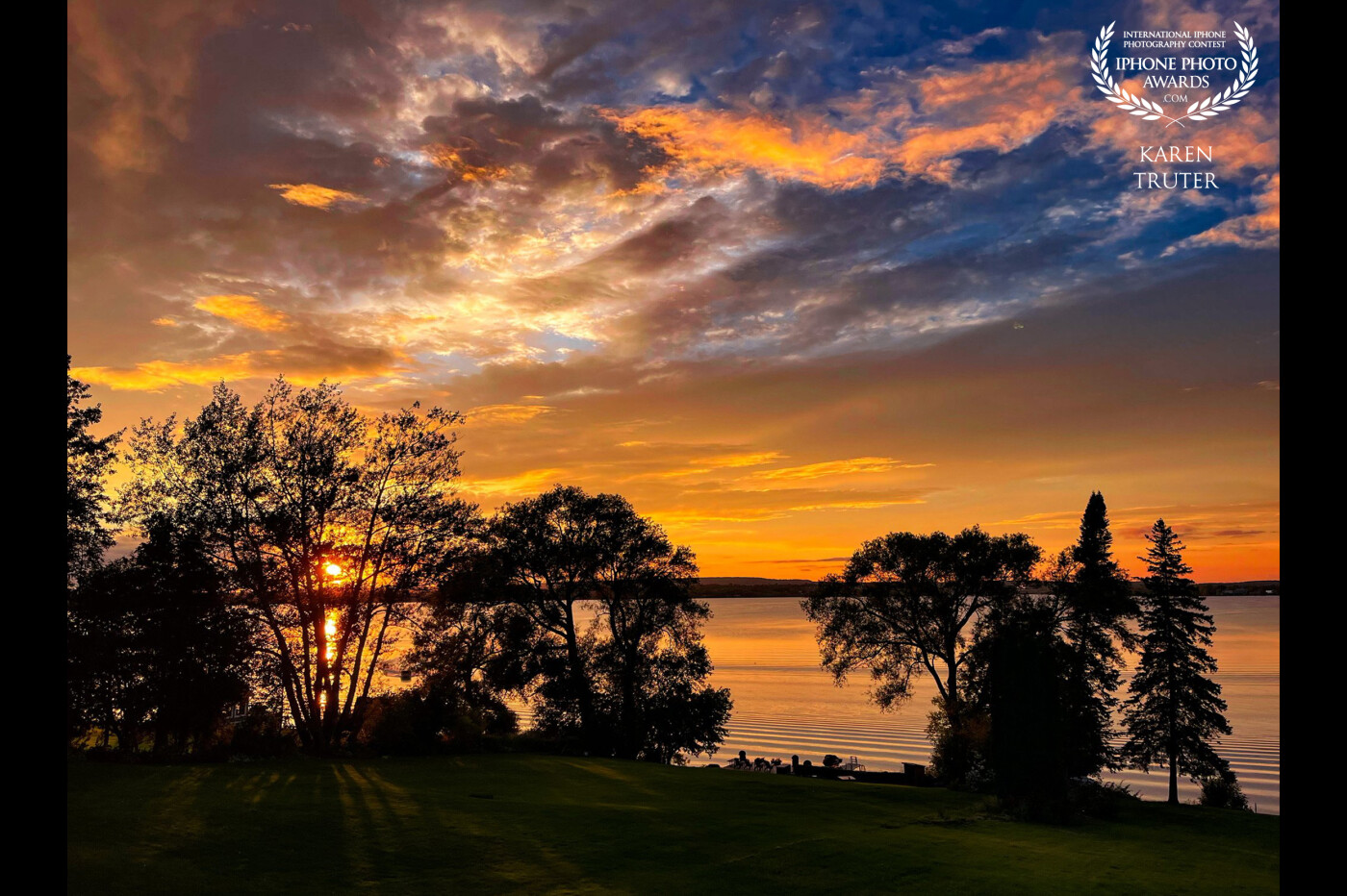 Sunset over Bay of Quinte, Ontario Canada<br />
I watched in awe as this magnificent sky developed and increased in beauty as the sun set behind the trees, casting shadows across the lawn…