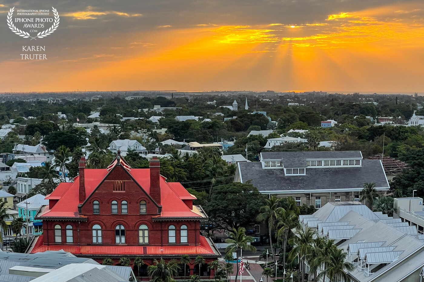 This photo was taken from our balcony on the Celebrity Apex cruise ship as we docked at Key West. The red building is the old Customs House and stood high and proud amongst the rest of the town. The rising sun added its own spectacle to the landscape.
