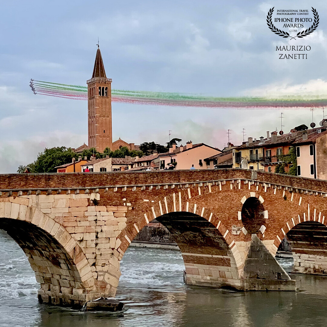 The ancient and the modern: the legendary "Frecce Tricolori" whiz across the sky over Verona, passing over Ponte Pietra.