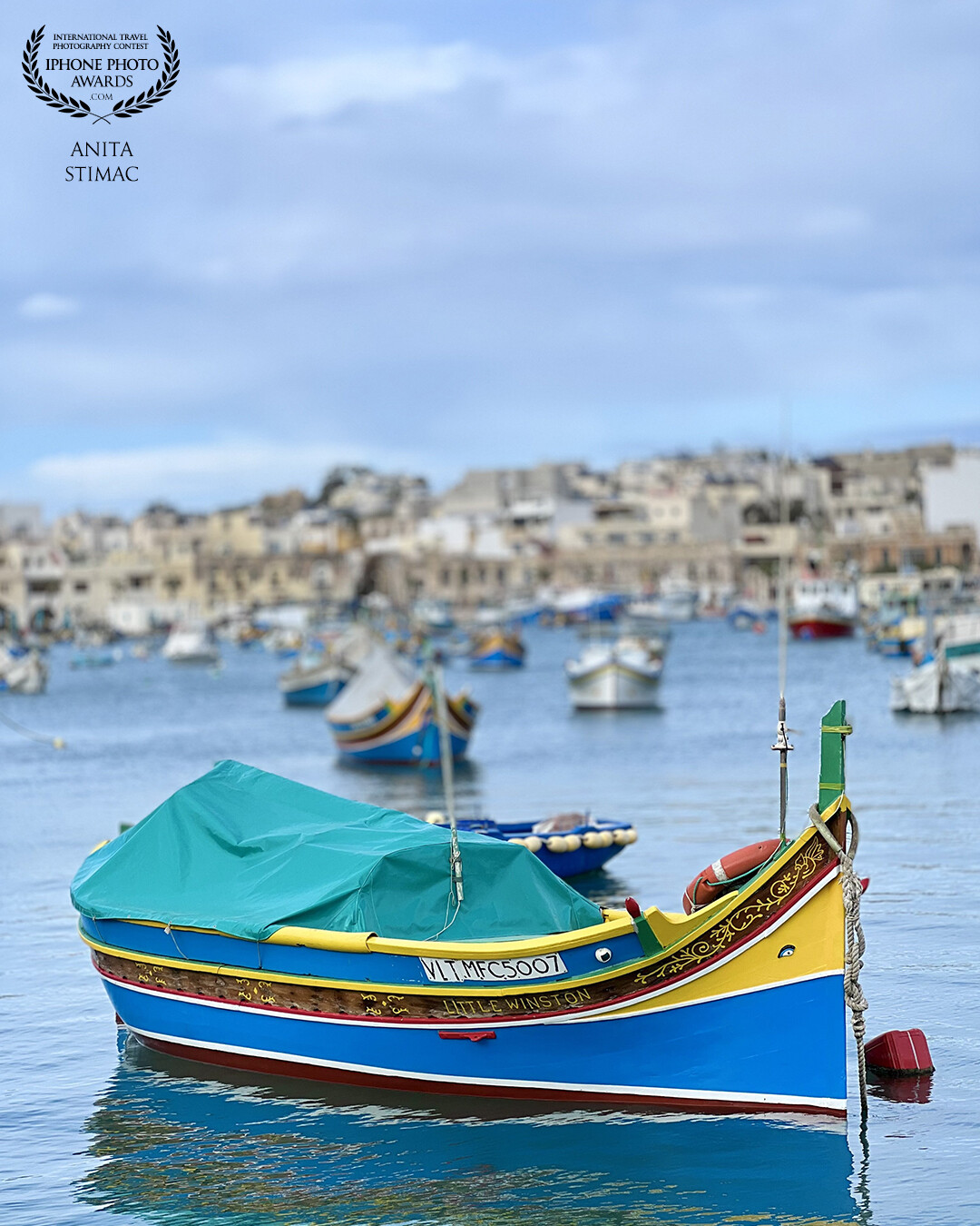 The colourful Luzza boats blend perfectly with the Mediterranean backdrop.