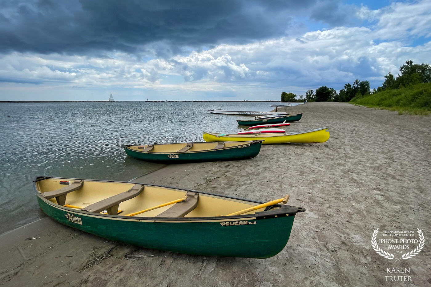 Cobourg, Ontario has an excellent Youth Sailing School in the summer where they are taught sailing, kayaking, paddle boarding and team canoeing. These were some of their canoes and kayaks resting on the shore of the marina.