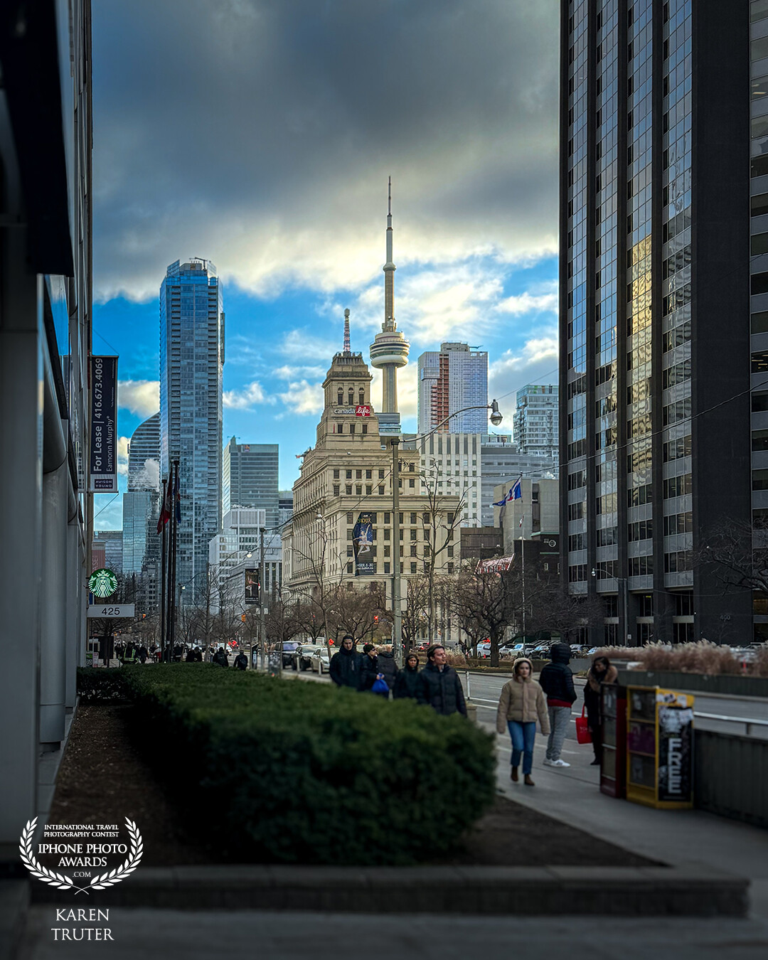 Walking the streets of Toronto, Canada, I turned the corner and this was the sight. The light captured the older building in a way that framed the famous CN tower and this scene was framed by the tall modern buildings on either side of the street. A “Frame within a Frame”.