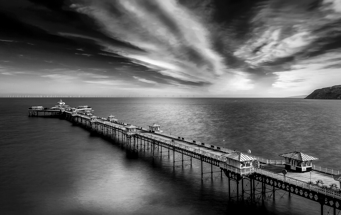 Clouds disappearing into the horizon  over the pier at Llandudno, North Wales.