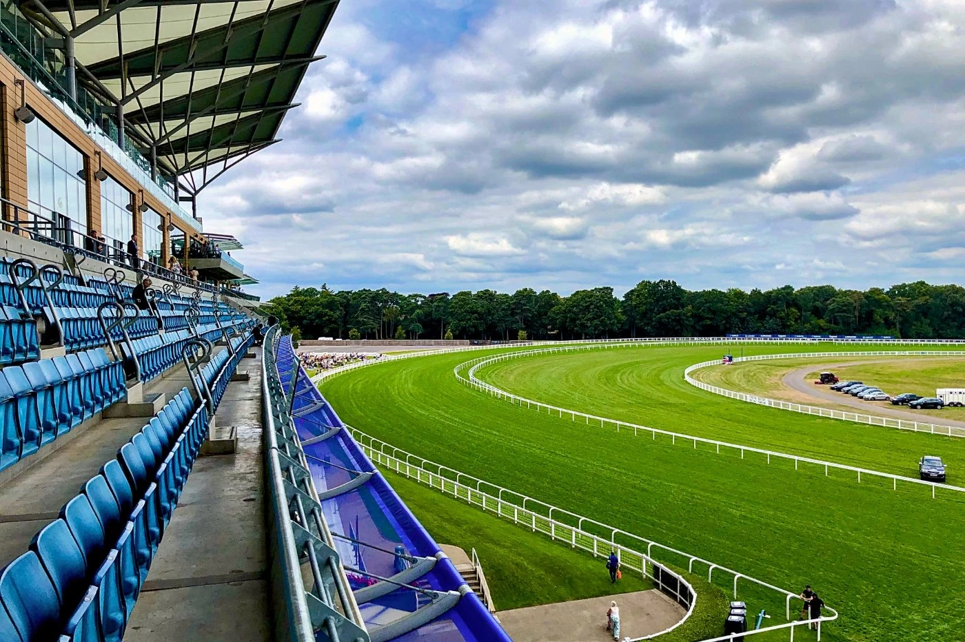 A day at the horse racing at Ascot showing the curve on the race track and the stand.
Wide Camera —...