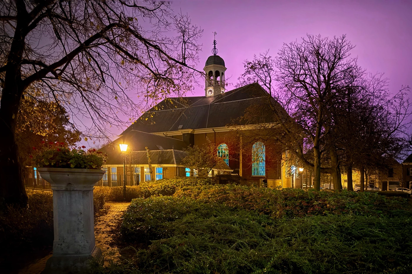 The church in my villages with the pink sky from the (pink) lights in the greenhouses.