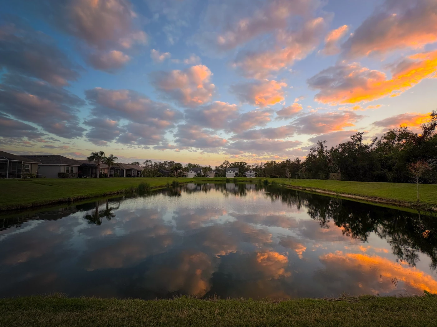 Mirror reflection of soft clouds at sunset