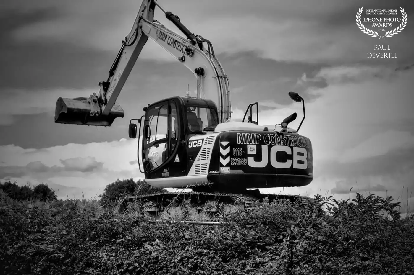 JCB digger at the back of our home where they we building a new estate.The soil was higher than the hedge the JCB was really high up!