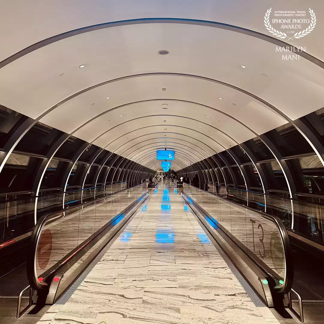 I love symmetry! I waited for a quiet moment on the walkway to the Jewel, Singapore to capture the symmetry here.